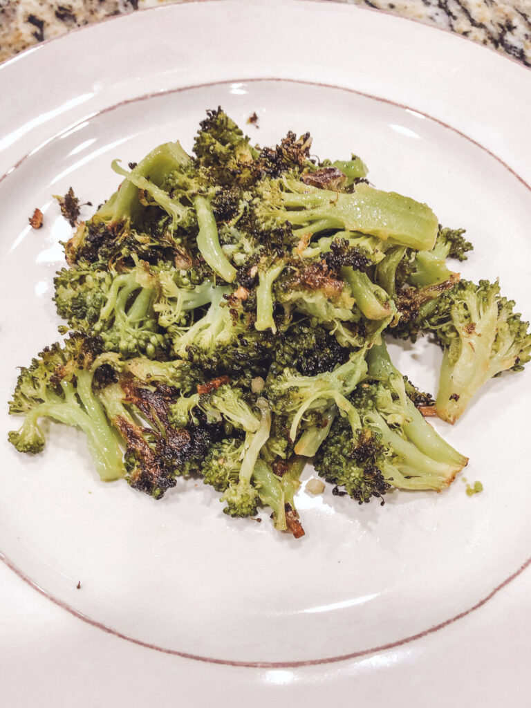 roasted garlic broccoli on a white plate
