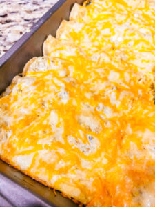 spinach and chicken enchiladas in a pan
