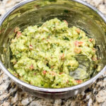 guacamole in a silver mixing bowl