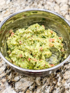 guacamole in a silver mixing bowl