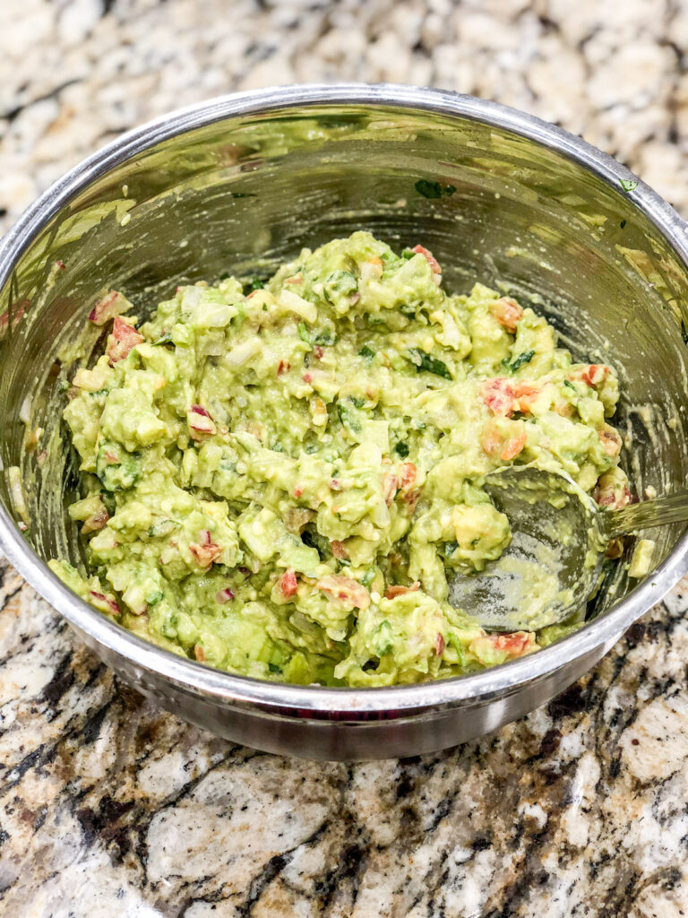 guacamole in a silver mixing bowl