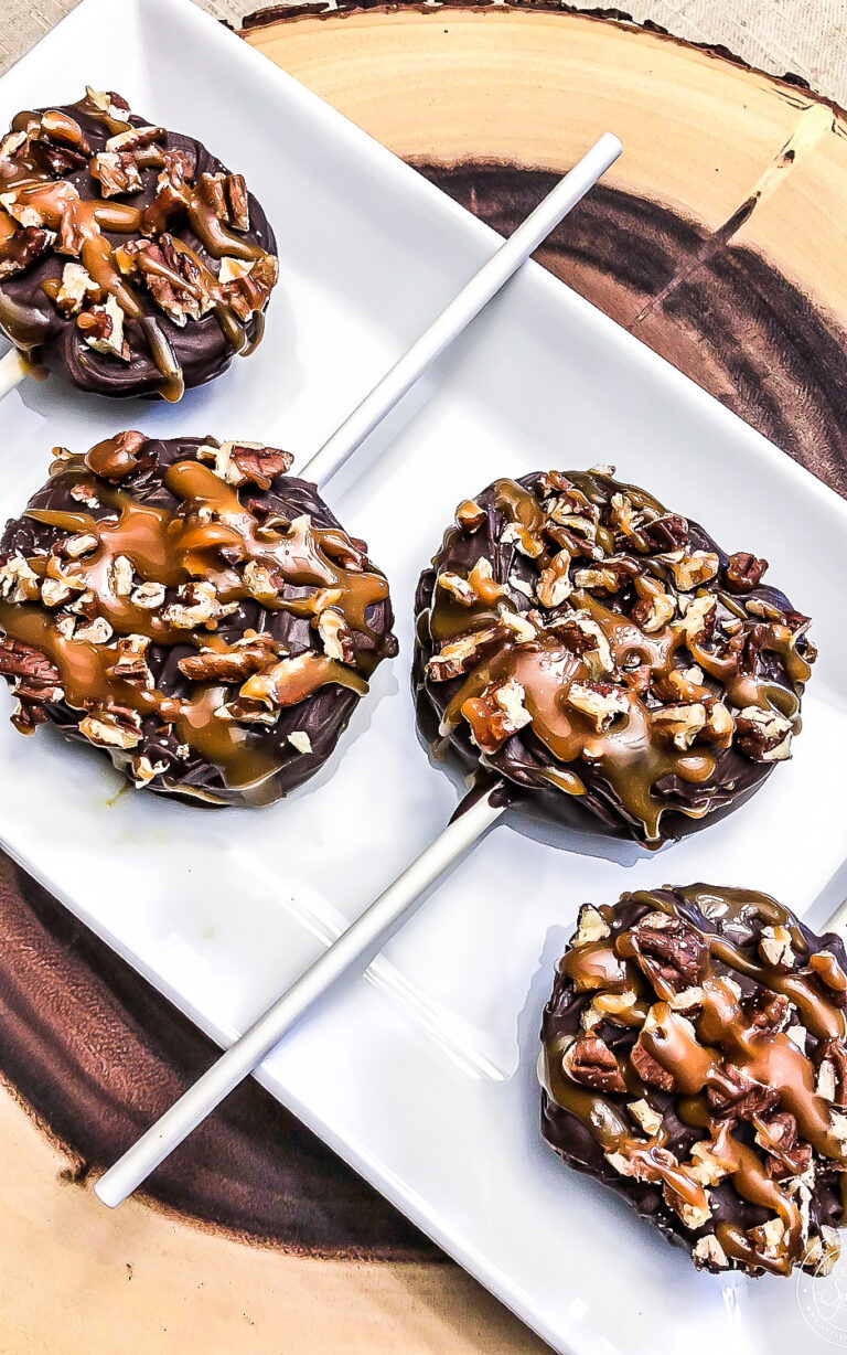 chocolate covered apple slices with pecans and caramel on top