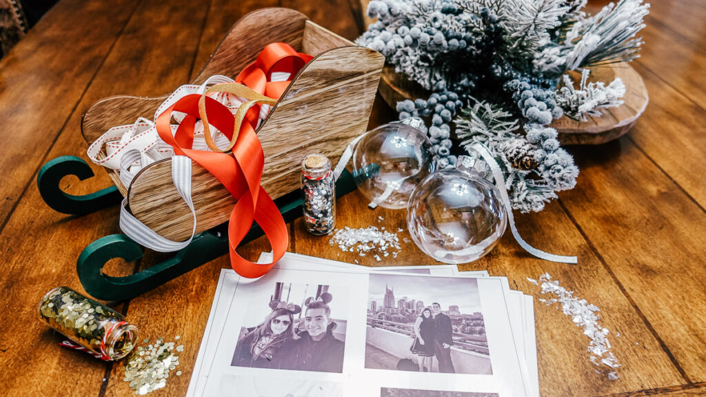printed photos and clear ornaments sitting on table