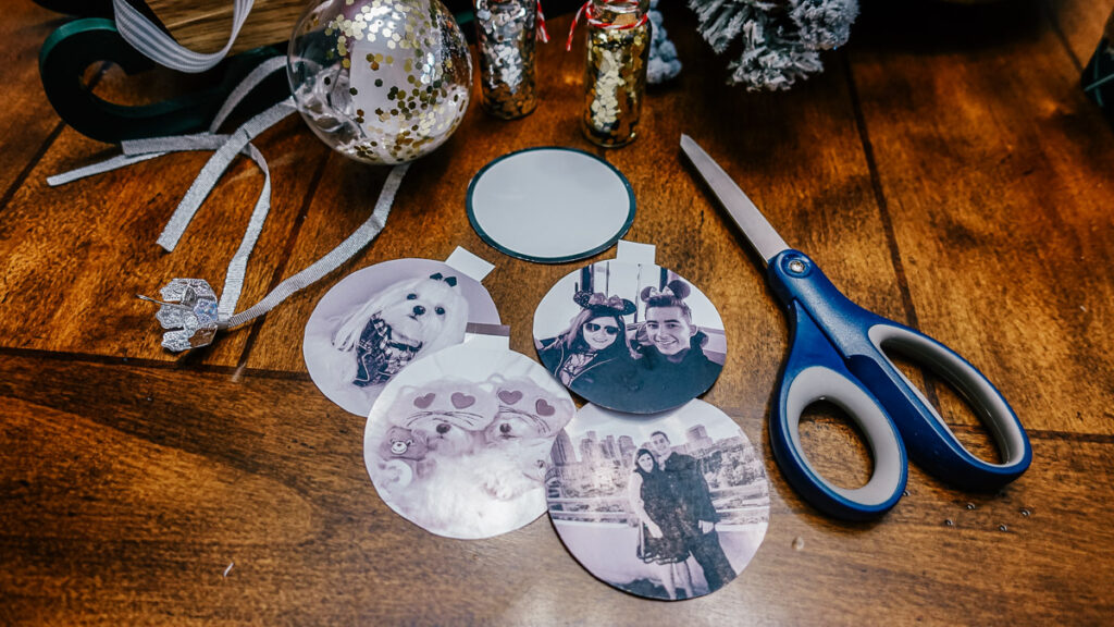 printed photos cut into circles with scissors laying on a table