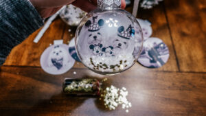 clear ornament with photo of two Maltese inside and glitter