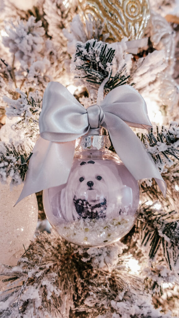 Maltese dog photo ornament tied with a silver bow hanging on Christmas tree