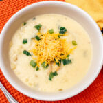 a white bowl with potato soup inside