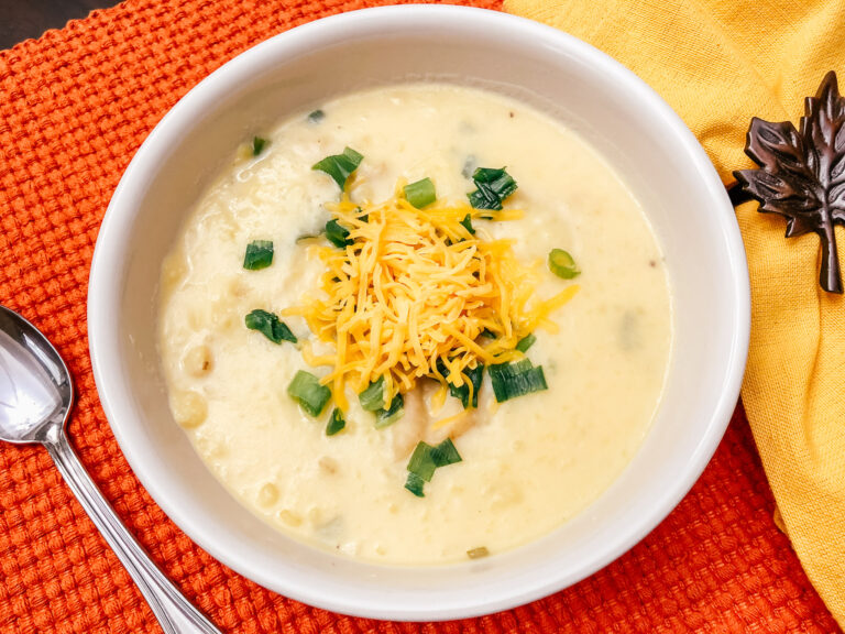 a white bowl with potato soup inside
