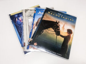 four DVDs on a white background
