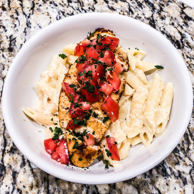 cajun chicken pasta in a white bowl