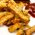 garlic fries on a white plate